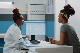 A female doctor explaining medical terms she found on her female patient full medical check-up